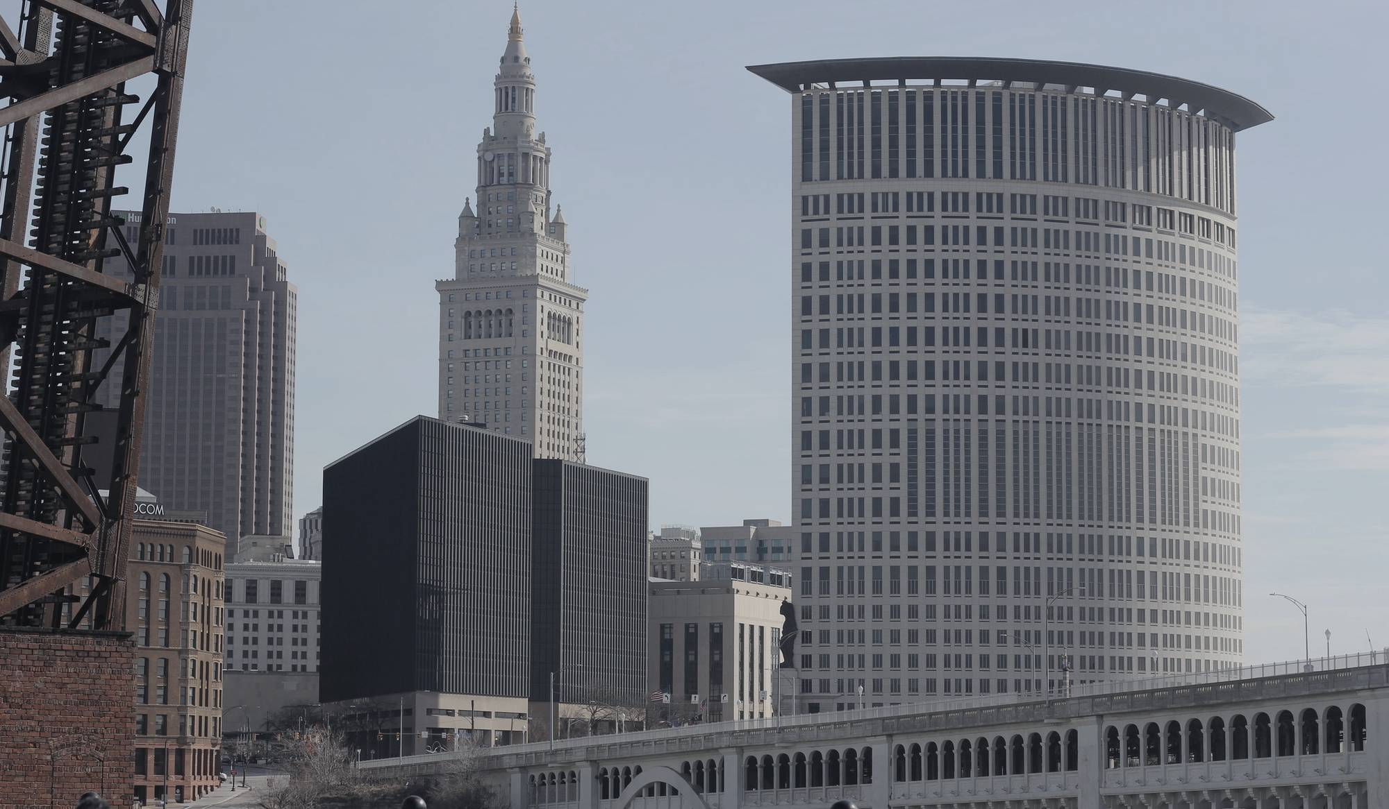 Downtown Cleveland under an overcast sky, the Terminal Tower and 200 Public Square seen past the Detroit-Superior bridge.